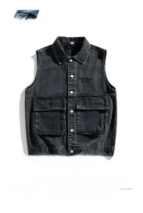 Detail view of washed grey denim vest with dual flap pockets and embroidered chest logo