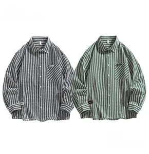 Close-up of striped cotton shirts showing herringbone texture, chest pocket and woven labels