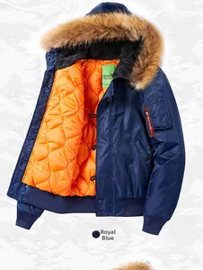 Detailed macro view of the royal blue MA-1 flight jacket with thick brown faux fur collar