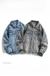 Close-up of distressed denim jacket featuring heavy wash details and vintage ripped texture
