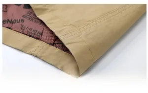 Detailed view of khaki jacket hem with double stitching and printed interior lining