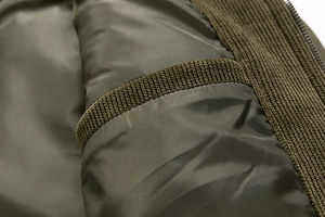 Detailed close-up of army green cotton jacket inner lining with functional pocket