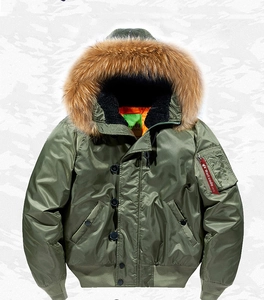 Detail of army green flight jacket with faux fur collar and vibrant orange lining