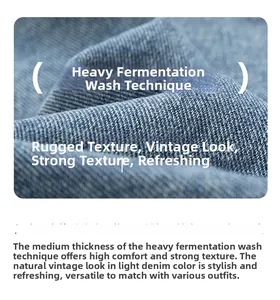 Macro shot of vintage blue denim fabric showing heavy enzyme wash texture and rugged fibers