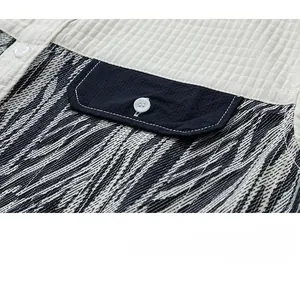 Detail of patchwork fabric showing white waffle knit, zebra print and corduroy pocket