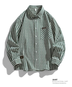 Close-up of herringbone cotton shirt texture with stitched chest pocket and patch