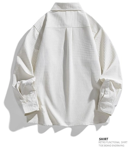 Detail of white waffle texture fabric on long sleeve men's shirt with back pleat