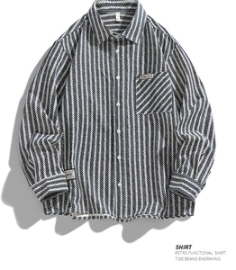 Detail of herringbone striped cotton shirt featuring a chest pocket and Timues patch