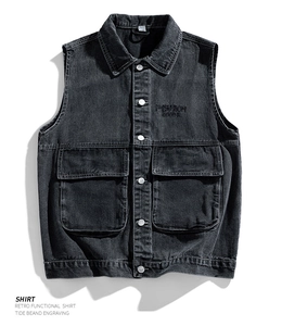 Close-up of retro black washed denim vest with utility pockets and embroidery detail