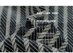 Close-up of black and white herringbone cotton shirt fabric showing weaving detail