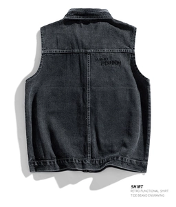 Macro shot of washed black denim vest back with FASHION embroidery and stitching