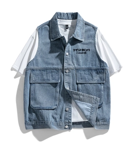 Detailed view of blue washed denim vest showing pocket details and high-quality texture