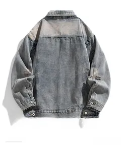 Rear view of vintage washed denim jacket featuring distressed elbow holes and metal buttons
