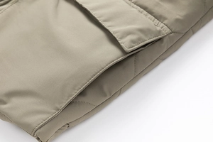 Detail view of the quilted stitching and flap pocket on this men casual khaki cotton jacket