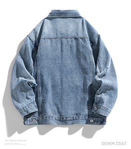 Detail view of light blue denim jacket with distressed textures and metal buttons