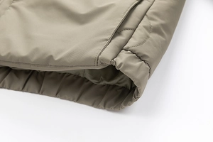 Detail of khaki men's casual cotton jacket featuring elastic hem and fine stitching