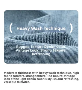 Detail of light blue denim fabric with heavy enzyme wash texture and vintage grain finish
