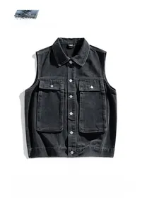 Detail of vintage washed denim vest with flap pockets and metallic buttons