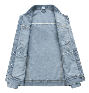 Detail view showing internal pockets and high-quality stitching on washed denim jacket