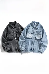 Detail view of heavy washed denim jackets in grey and blue with vintage distressed texture