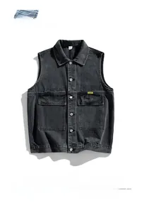 Detail view of dark grey washed denim vest with tactical flap pockets and metal buttons
