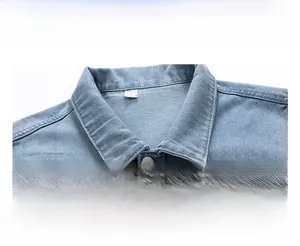 Detail shot of light blue washed denim vest showing classic lapel and metallic buttons