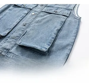 Detail of light blue washed denim vest showing metal buttons and utility pocket design