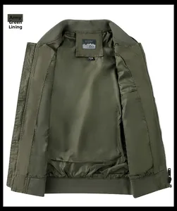 Detailed interior of army green bomber jacket with quilted lining and inner pocket