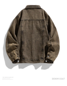 Detailed back view of vintage tan heavy denim jacket with structural stitching