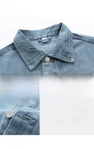 Close-up of retro metal buttons and classic pointed collar on light blue washed denim vest