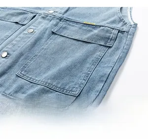 Detailed macro view of denim vest showing silver metal button and yellow brand label tag