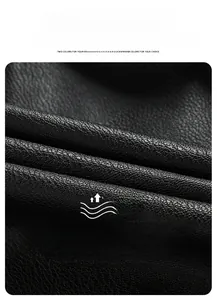 Detailed macro view of black faux leather jacket showing thick windproof lychee texture