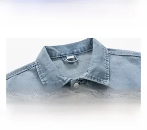 Close-up of vintage washed light blue denim jacket collar with metal buttons and neat stitching
