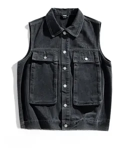 Close-up of retro charcoal black denim vest featuring two large pockets and metal buttons
