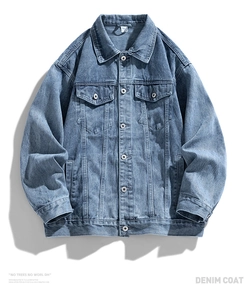 Detailed flat lay of light blue denim jacket showing premium fabric and button pockets