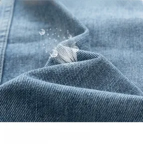 Macro shot of blue washed denim fabric texture with detailed diagonal twill weaving