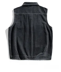Detail of dark grey washed denim vest featuring vintage embroidery on the back hem