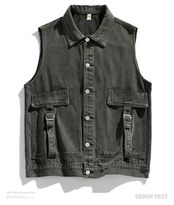 Detailed macro view of charcoal grey denim vest featuring utility pockets and metal hardware