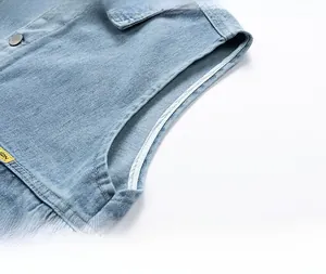 Detailed macro view showing the clean armhole stitching and light blue washed denim fabric