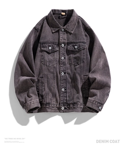 Flat lay of vintage washed black oversized denim jacket with metal buttons and chest pockets