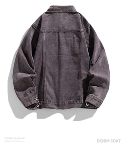 Rear view of washed grey denim jacket showing loose fit silhouette and back yoke seams