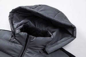 Detailed macro view of hooded puffer jacket with warm black fleece lining and zipper