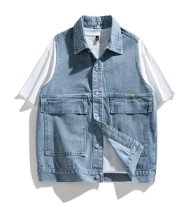 Detail of light blue denim vest pockets and classic collar with white t-shirt layer