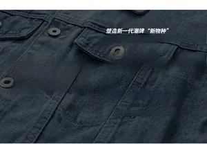 Close-up of a blue denim jacket featuring metal buttons and double-stitched flap pockets