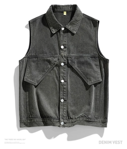 Detailed view of two large irregular pockets on a heavy washed grey denim vest