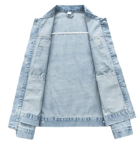 Close-up of light blue denim jacket showing washed texture, metal buttons and neat stitching