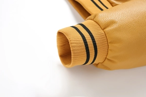Detail of the ginger yellow PU leather jacket sleeve with black striped ribbed knit cuffs