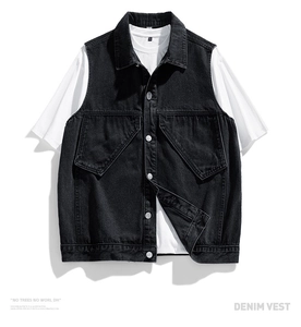 Detail of black denim vest with cargo pockets and metallic buttons over a white t-shirt