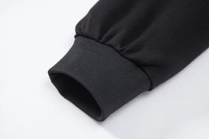 Detailed close-up of the elastic ribbed cuffs on a black padded jacket sleeve