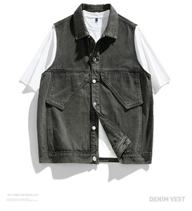 Detail of vintage washed dark grey denim vest showing metal buttons and front pockets